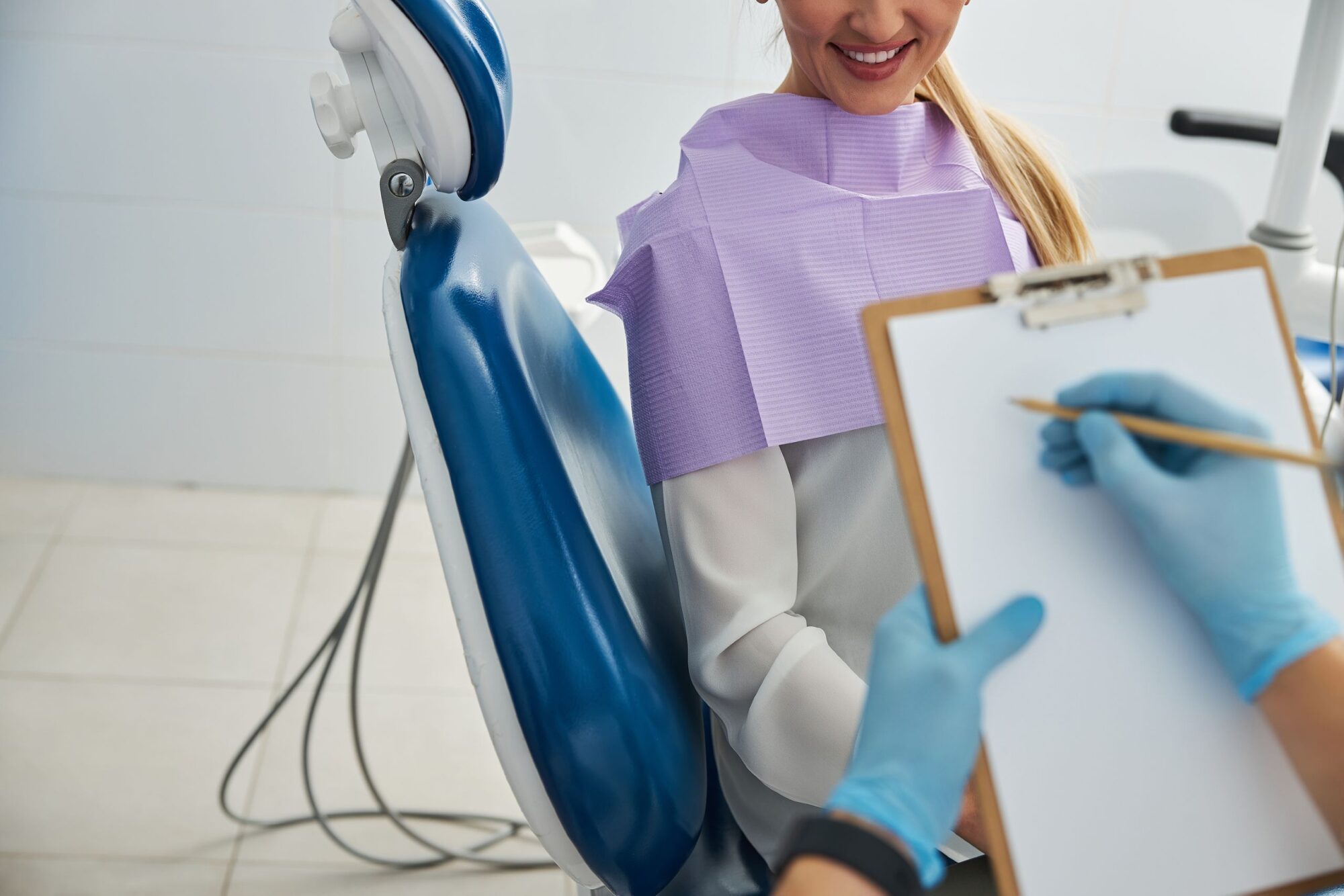 Person making notes of dental office patient